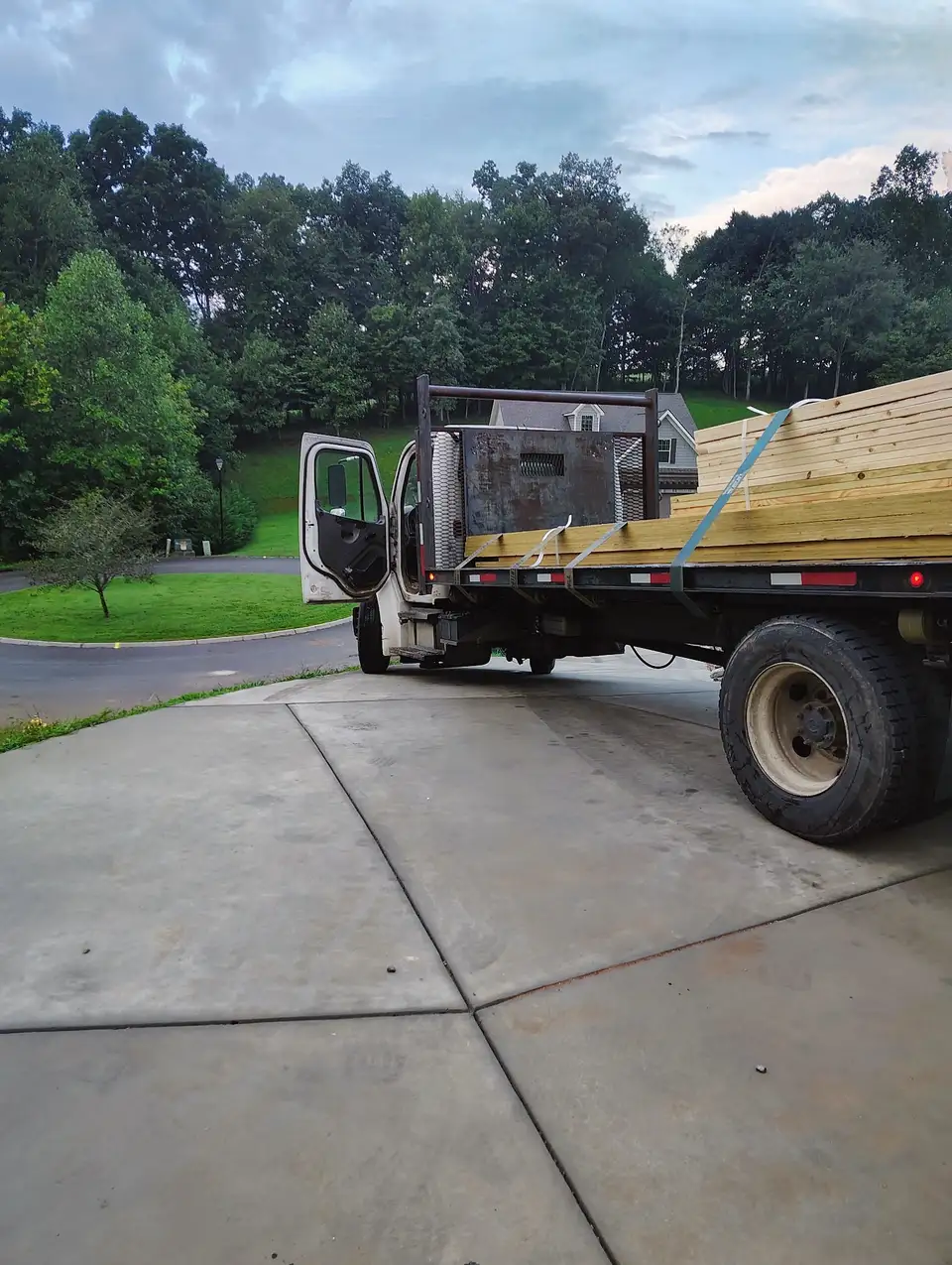 On-Site Material Management: flatbed truck delivering a strapped load of framing lumber to a job site