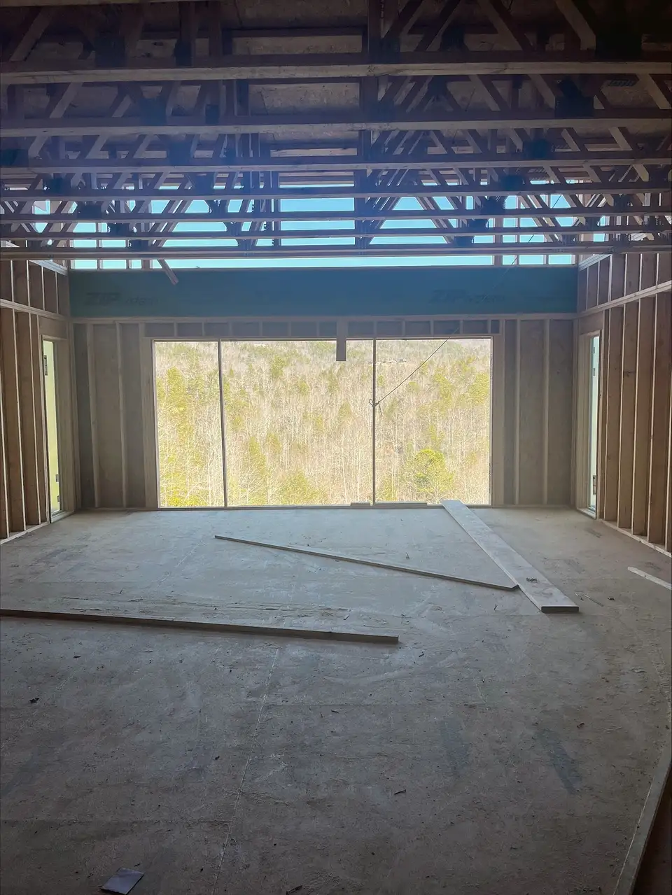 Framed room with floor trusses overhead, the kind of framing a material take-off counts