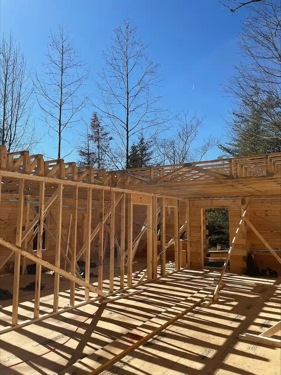 Framing lumber standing as wall frames on a new subfloor