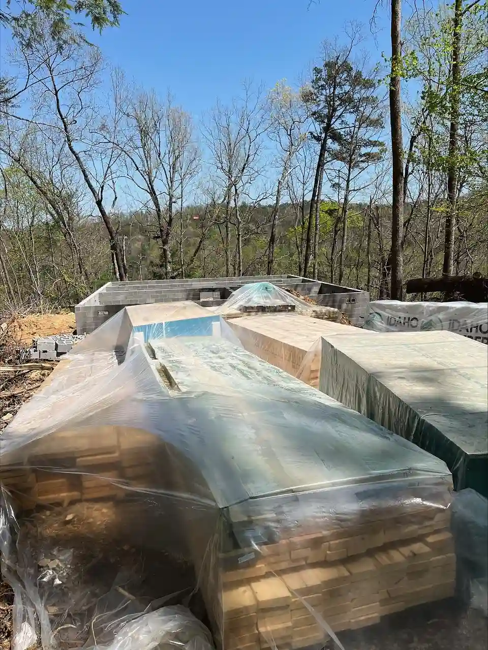 Wrapped building material bundles staged on a job site